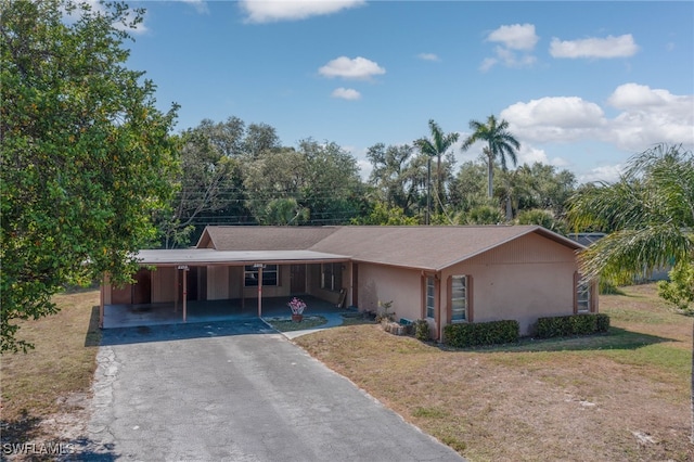 2215 Marilyn Ln, Fort Myers, FL 33905 - ranch-style home with a front yard, stucco siding, driveway, and an attached carport