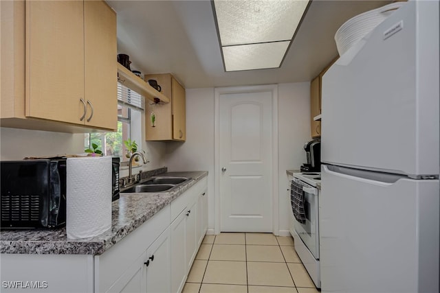 2215 Marilyn Ln, Fort Myers, FL 33905 - kitchen with white appliances, light tile patterned floors, white cabinets, and a sink