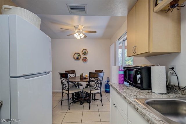 2215 Marilyn Ln, Fort Myers, FL 33905 - kitchen with ceiling fan, visible vents, black microwave, freestanding refrigerator, and light tile patterned flooring