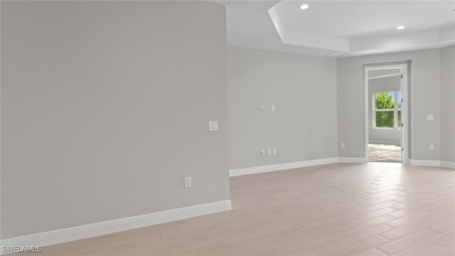 17825 Summerland Key Ct, Fort Myers, FL 33908 - empty room featuring baseboards, recessed lighting, a raised ceiling, and light wood-type flooring