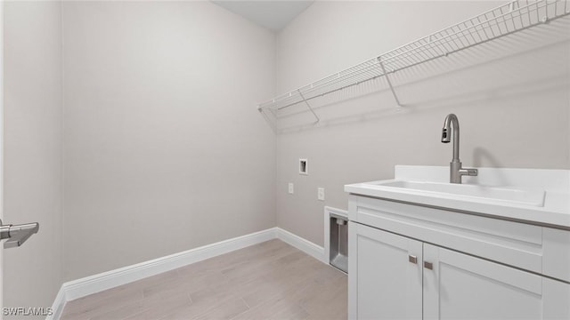 17825 Summerland Key Ct, Fort Myers, FL 33908 - laundry area featuring hookup for a washing machine, cabinet space, light wood-style flooring, baseboards, and electric dryer hookup
