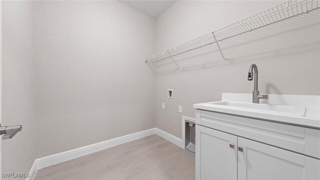 17825 Summerland Key Ct, Fort Myers, FL 33908 - washroom with washer hookup, cabinet space, light wood-style floors, baseboards, and electric dryer hookup