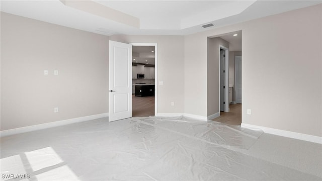 17825 Summerland Key Ct, Fort Myers, FL 33908 - unfurnished room with light carpet, a tray ceiling, baseboards, and recessed lighting