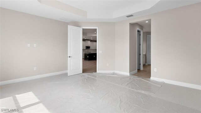17825 Summerland Key Ct, Fort Myers, FL 33908 - empty room featuring light carpet, baseboards, a raised ceiling, and recessed lighting
