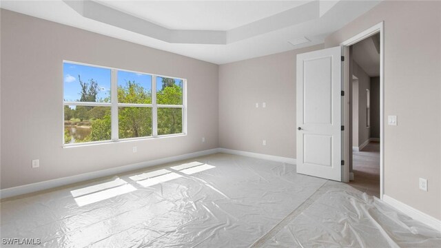 17825 Summerland Key Ct, Fort Myers, FL 33908 - spare room featuring a raised ceiling and baseboards