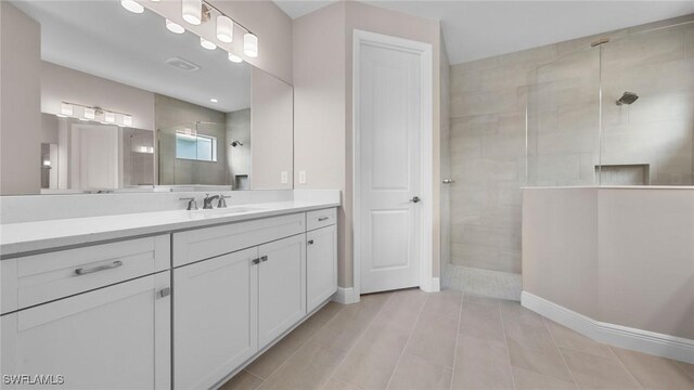 17825 Summerland Key Ct, Fort Myers, FL 33908 - bathroom featuring a walk in shower, vanity, baseboards, and tile patterned flooring