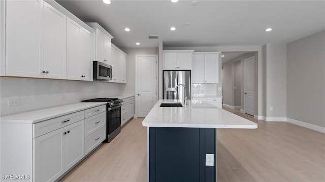 17825 Summerland Key Ct, Fort Myers, FL 33908 - kitchen featuring stainless steel appliances, a sink, decorative backsplash, recessed lighting, and a center island with sink