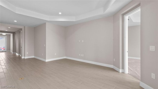 17825 Summerland Key Ct, Fort Myers, FL 33908 - empty room with a raised ceiling, light wood-style flooring, recessed lighting, and baseboards