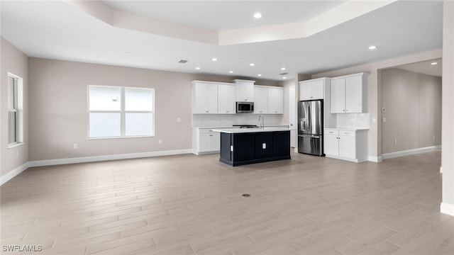 17825 Summerland Key Ct, Fort Myers, FL 33908 - kitchen featuring open floor plan, appliances with stainless steel finishes, light countertops, a kitchen island with sink, and recessed lighting