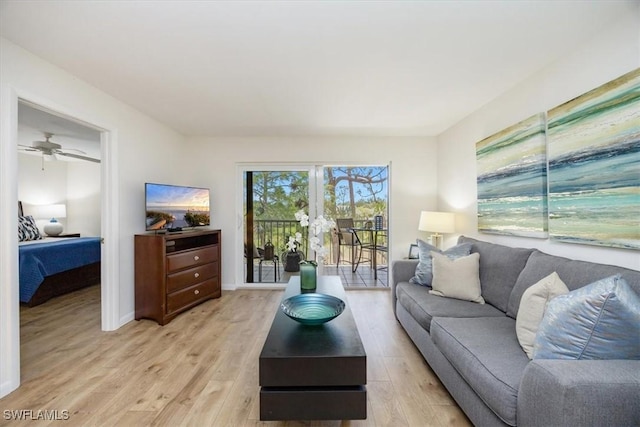 living room with ceiling fan and light wood-style floors