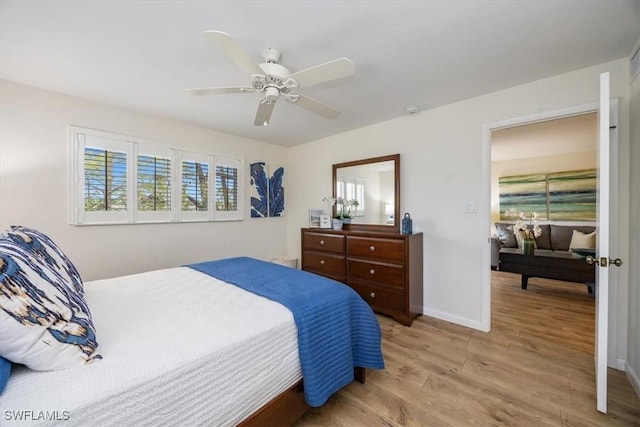 bedroom featuring light wood finished floors, ceiling fan, and baseboards