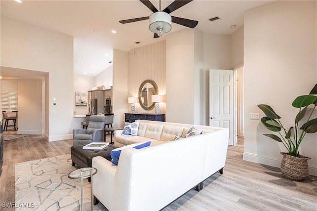 831 Sailaway Ln Unit 203, Naples, FL 34108 - living room with high vaulted ceiling, a ceiling fan, light wood finished floors, baseboards, and recessed lighting