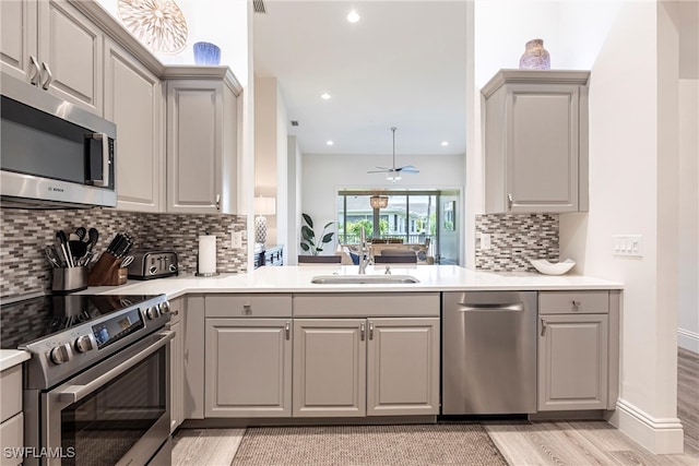 831 Sailaway Ln Unit 203, Naples, FL 34108 - kitchen with appliances with stainless steel finishes, gray cabinets, a sink, light wood-style floors, and recessed lighting