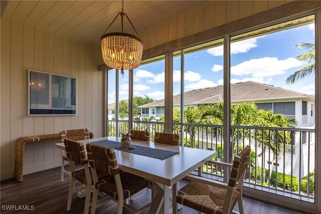 831 Sailaway Ln Unit 203, Naples, FL 34108 - sunroom featuring a chandelier and a residential view