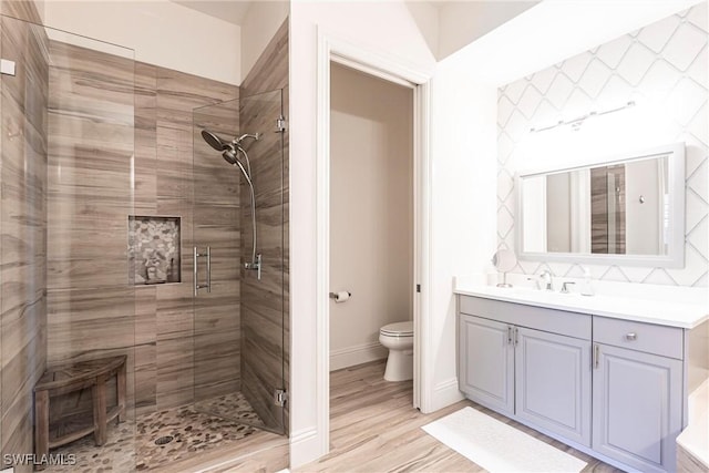 831 Sailaway Ln Unit 203, Naples, FL 34108 - bathroom with a shower stall, toilet, vanity, and wood finished floors
