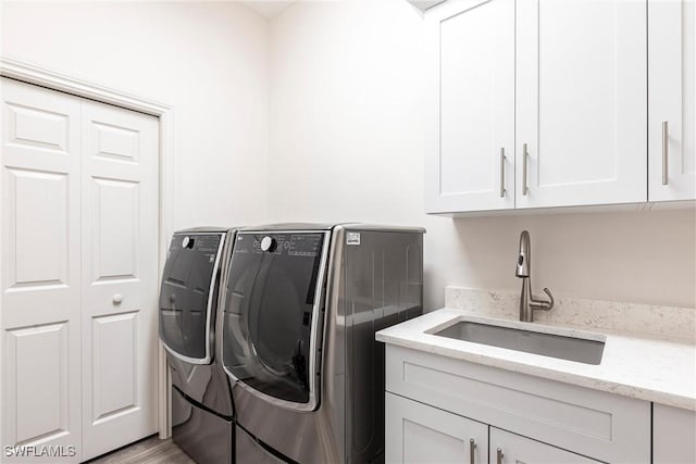831 Sailaway Ln Unit 203, Naples, FL 34108 - washroom with separate washer and dryer, cabinet space, and wood finished floors