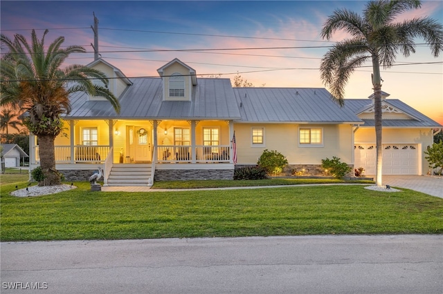 27130 Holly Ln, Bonita Springs, FL 34135 - view of front of home featuring an attached garage, a lawn, driveway, and covered porch