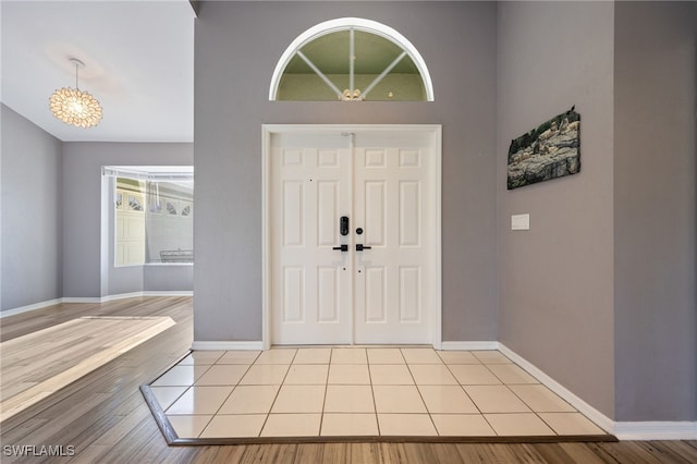 foyer entrance with light wood finished floors and baseboards