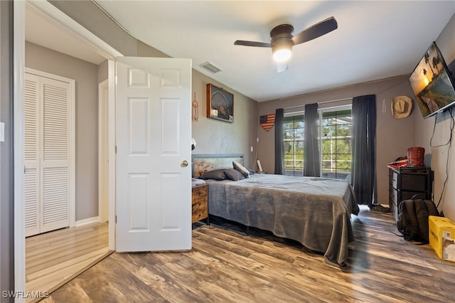 bedroom with visible vents, ceiling fan, and wood finished floors
