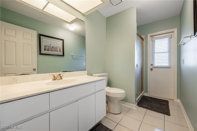full bathroom with tile patterned floors, toilet, vanity, baseboards, and a stall shower