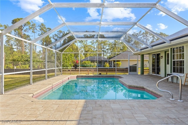 outdoor pool with fence and a patio area