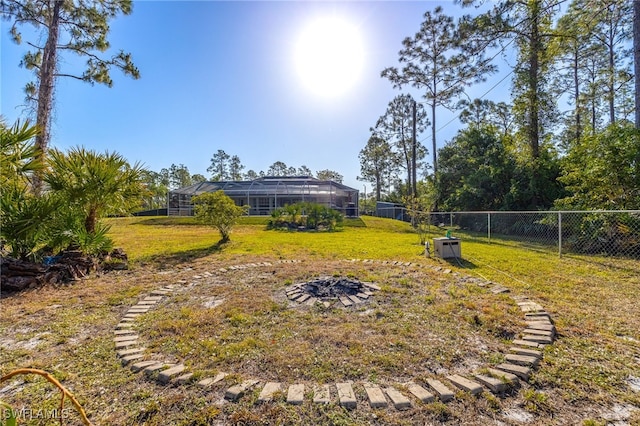 view of yard featuring a lanai and fence