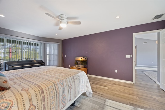 bedroom featuring visible vents, light wood-type flooring, recessed lighting, and baseboards