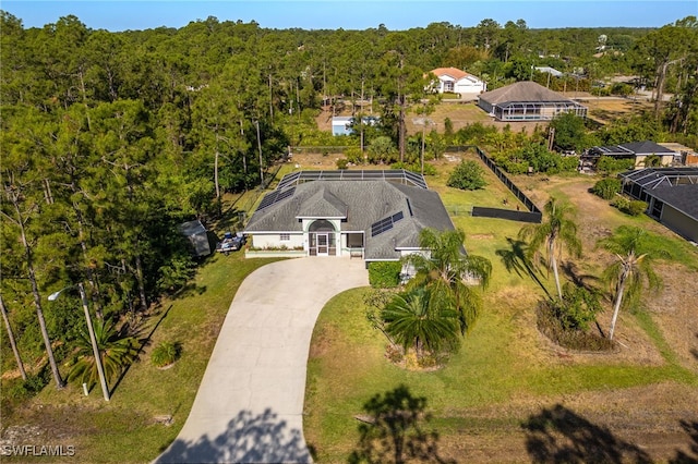 drone / aerial view featuring a wooded view