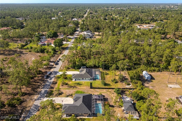 aerial view featuring a wooded view