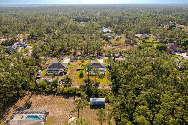 birds eye view of property with a wooded view