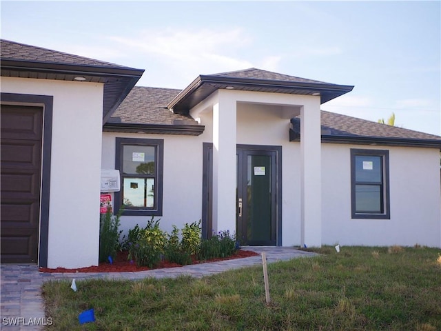1708 El Dorado Blvd N, Cape Coral, FL 33993 - view of exterior entry with stucco siding and roof with shingles
