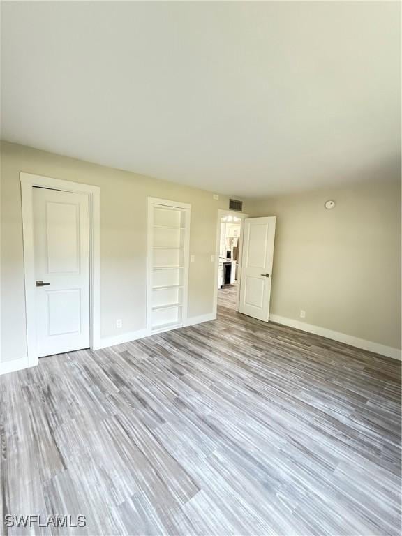 530 Broad Ave S Unit 530, Naples, FL 34102 - empty room featuring wood finished floors, visible vents, and baseboards