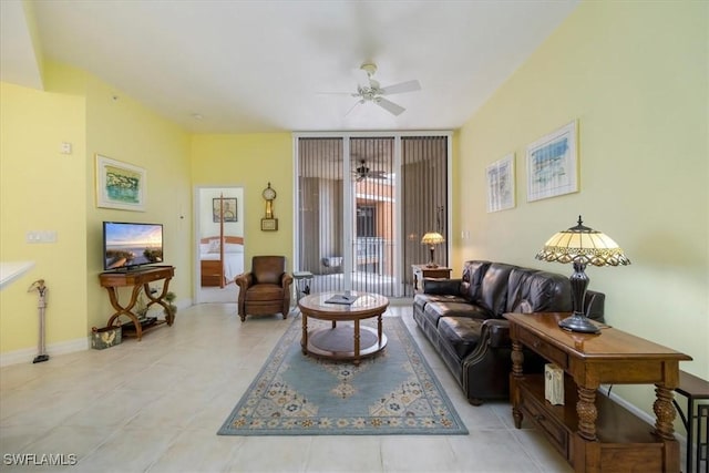 living room featuring baseboards, a ceiling fan, and light tile patterned flooring