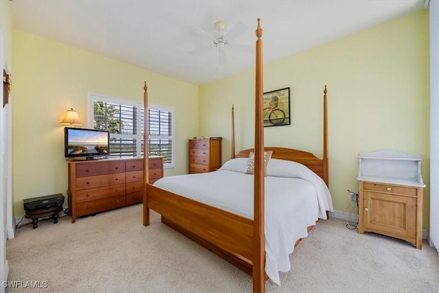 bedroom with ceiling fan and light carpet