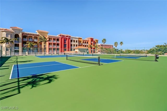 view of tennis court featuring fence and community basketball court