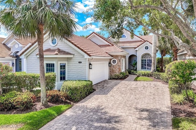 8442 Mallards Way, Naples, FL 34114 - mediterranean / spanish-style home featuring decorative driveway, an attached garage, and a tile roof