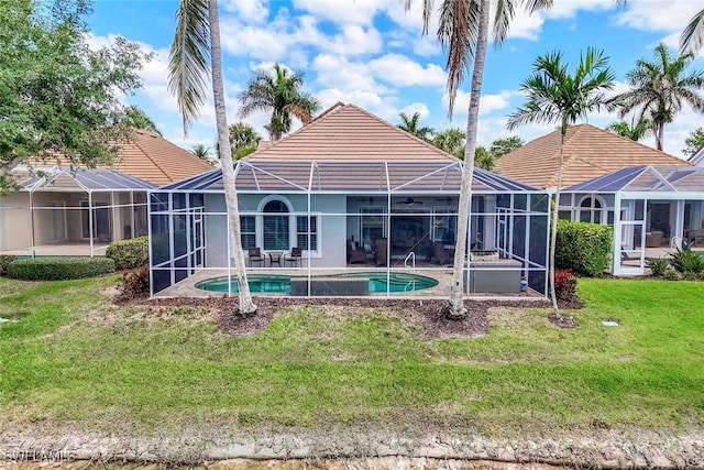 8442 Mallards Way, Naples, FL 34114 - rear view of house featuring stucco siding, an outdoor pool, a patio, a tiled roof, and a yard