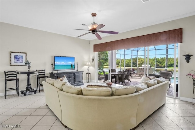 8442 Mallards Way, Naples, FL 34114 - living room featuring visible vents, baseboards, a sunroom, a ceiling fan, and light tile patterned floors