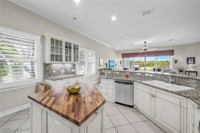 8442 Mallards Way, Naples, FL 34114 - kitchen featuring stainless steel dishwasher, visible vents, light tile patterned flooring, butcher block countertops, and a sink