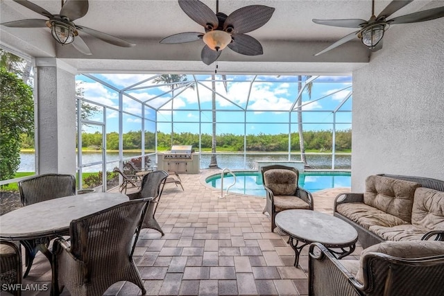8442 Mallards Way, Naples, FL 34114 - exterior space with an outdoor kitchen, a ceiling fan, a lanai, and a water view