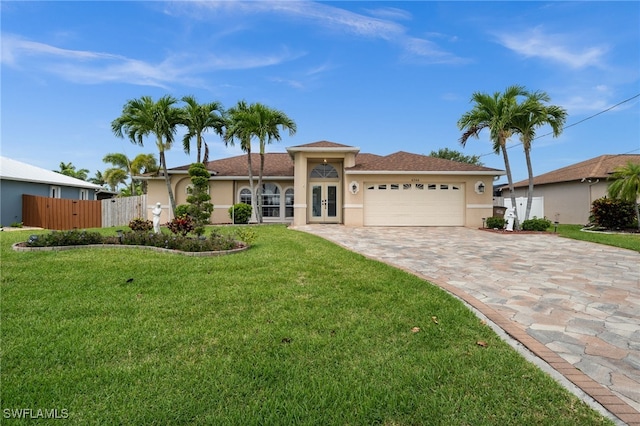 view of front of house with a garage, stucco siding, a front yard, decorative driveway, and french doors