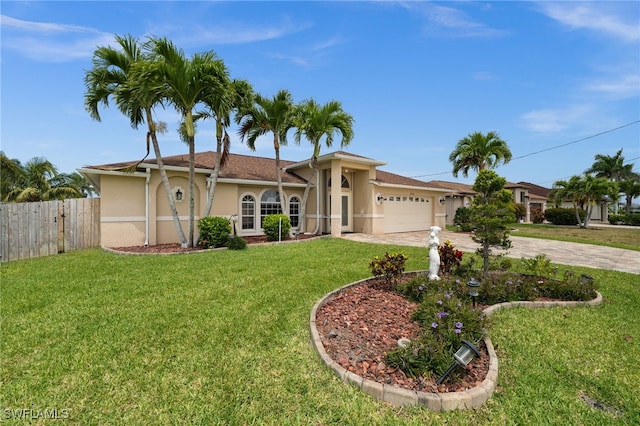 view of front of property featuring fence, an attached garage, a front lawn, stucco siding, and concrete driveway