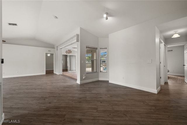 unfurnished living room with visible vents, baseboards, lofted ceiling, and dark wood-style floors