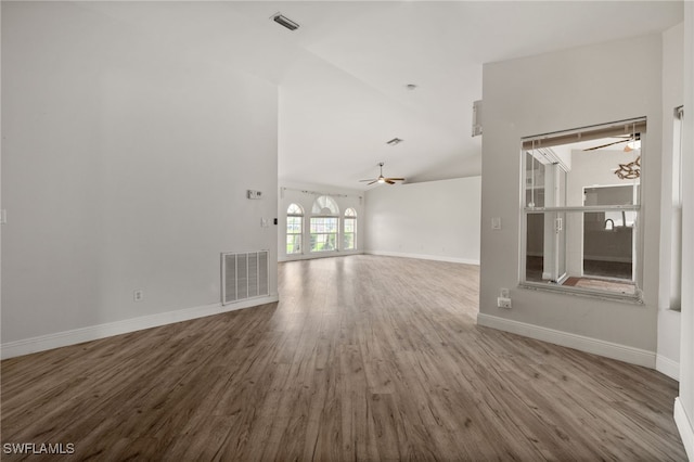 unfurnished living room featuring visible vents, ceiling fan, wood finished floors, and vaulted ceiling