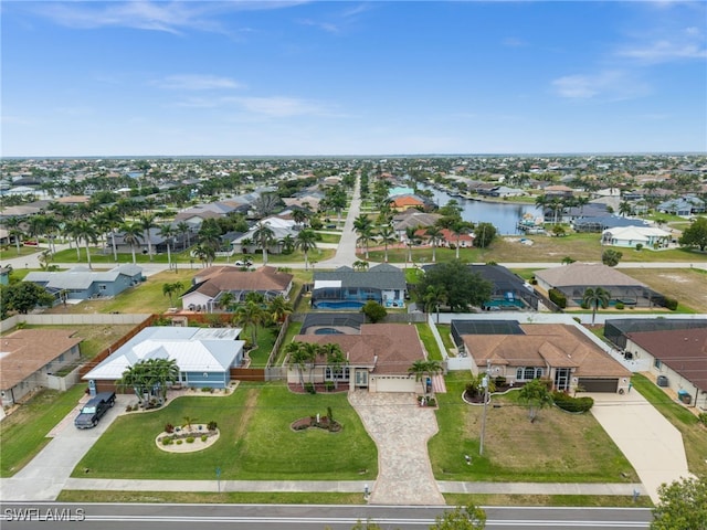 birds eye view of property with a residential view and a water view