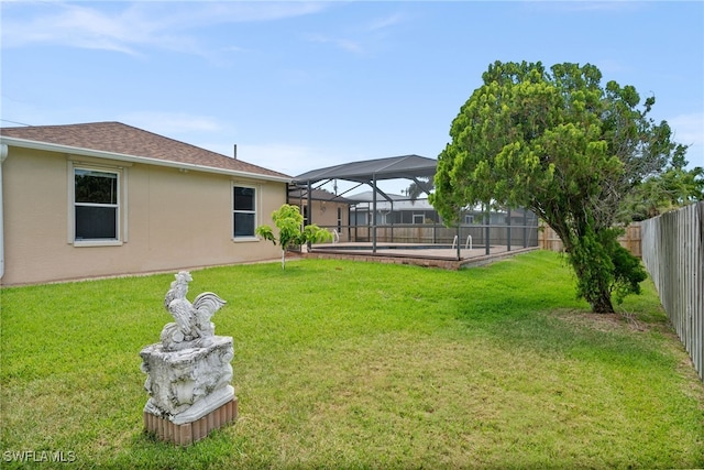 view of yard featuring a fenced in pool, a fenced backyard, and a lanai