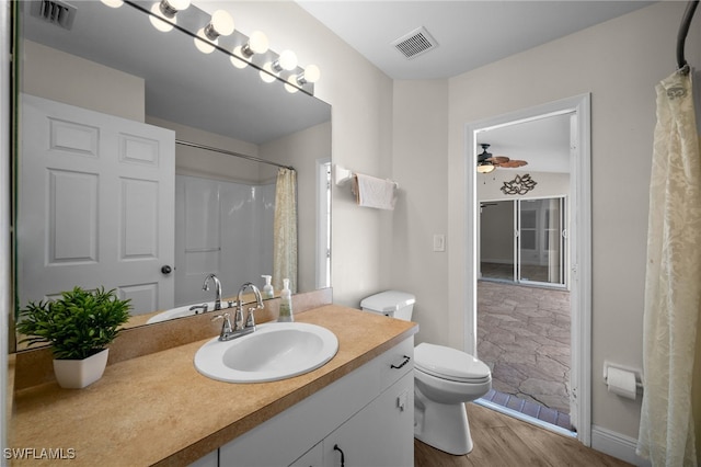 bathroom with visible vents, ceiling fan, wood finished floors, and toilet