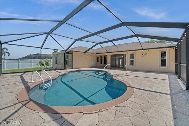 view of pool featuring a fenced in pool, glass enclosure, and a patio area