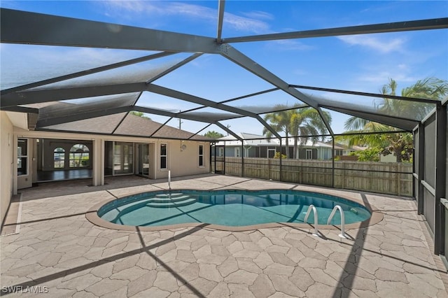 view of pool featuring a fenced in pool, fence, a lanai, and a patio area