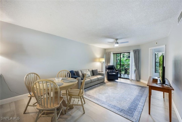 15177 Parkside Dr Unit 104, Fort Myers, FL 33908 - living room featuring a textured ceiling, a ceiling fan, wood finished floors, and baseboards